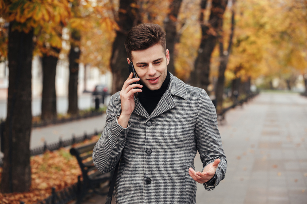 Gay man talking on phone dating chat line